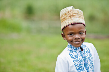 Portrait of african boy kid in traditional clothes at park.