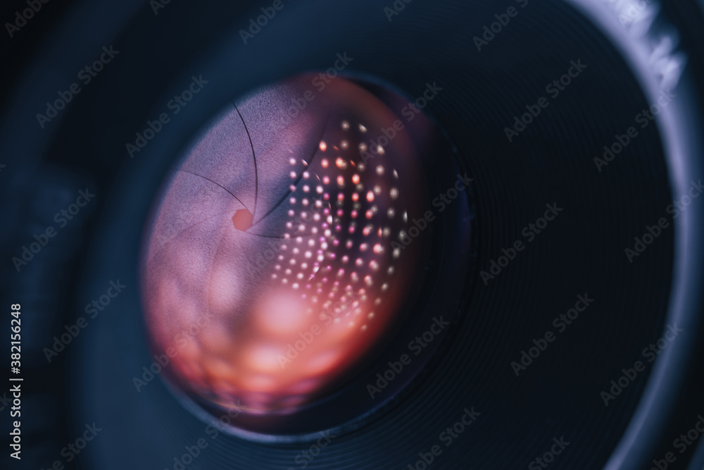 Fototapete close up beautiful camera lens on a dark with red reflection light background. macro view.