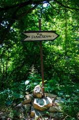 Una freccia di legno che indica la direzione della Via Francigena sul tratto appenninico