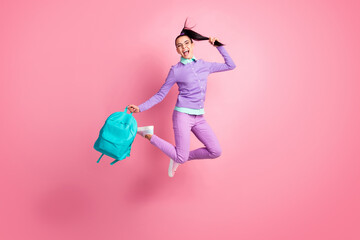 Full length photo of girl jump hold bag tail open mouth wear eyewear purple pullover pants sneakers...