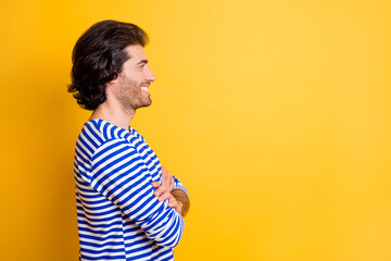 Profile side photo of positive attractive man look on empty space with cross hands isolated over...