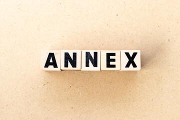 Alphabet letter block in word annex on wood background