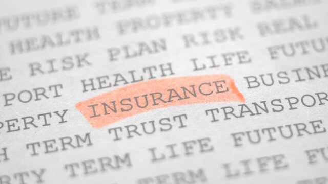 Macro shot of the word "INSURANCE" highlighted with a pink marker