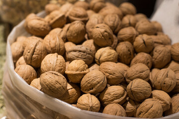 Walnuts with and without shells. Background of fresh walnuts.