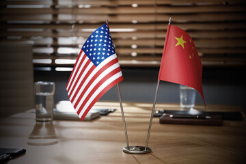 USA and China flags on wooden table in office. International relations