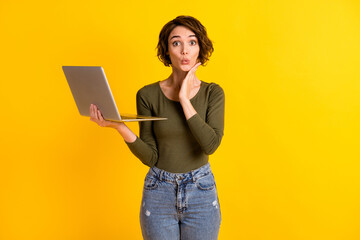 Photo of astonished lady hold laptop touch face with hand isolated over vivid yellow color background - obrazy, fototapety, plakaty