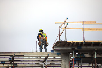 construction site worker at work roof beams