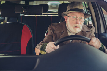 Photo of pensioner grandpa staring road hold steering wheel drive wear brown coat headwear specs...