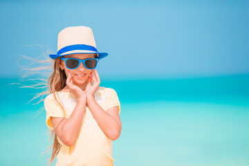Fototapeta premium Cute little girl at beach during summer vacation