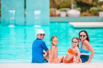 Fototapeta premium Happy family of four on beach vacation together