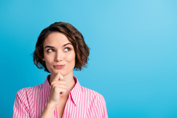 Photo of curly cheerful thoughtful cute lady dressed casual outfit arm finger chin look empty space isolated blue color background