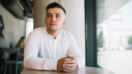 Thoughtful man waiting for meeting in cafe