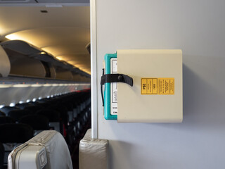 Protective breathing equipment ( PBE or AVOX in aviation word ) secured in stowage on aircraft wall...