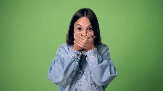 woman with surprise and shocked facial expression on green screen chroma key background on green screen chroma key background