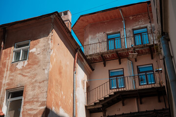 Fototapeta na wymiar old city poor building ghetto district exterior facade walls and windows in Eastern Europe town street