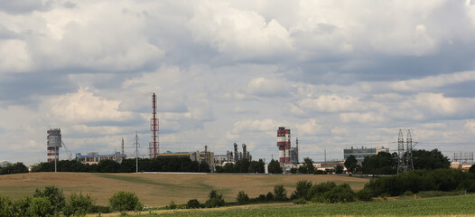 Fototapeta premium chemical plant among sown fields, production of chemicals.