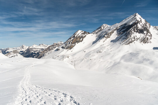 Snowshoes tracks on the gemmi pass near Leukerbad in Valais on a sunny winter day in Switzerland