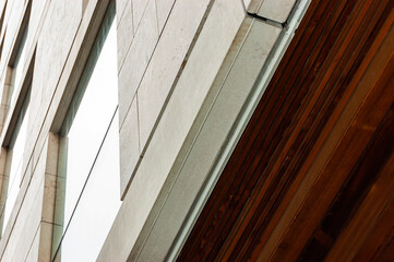 Modern facade and windows cladding with stone and ceiling paneling with wood