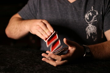 card magician practicing sleight of hand magic card spring
