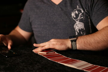 card magician practicing sleight of hand magic