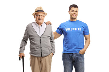 Volunteer helping an elderly man with a cane