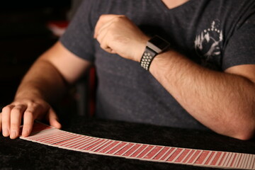 card magician practicing sleight of hand magic