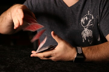 card magician practicing sleight of hand magic