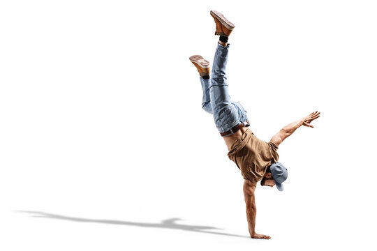Young fit man in jeans performing a one handstand
