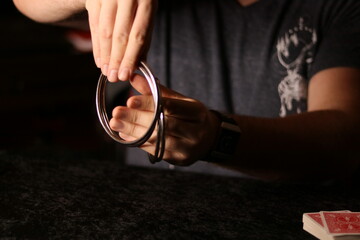 close up of a magician practicing a ring trick