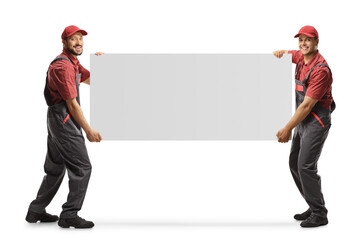 Full length shot of two workers in uniforms carrying a blank panel board