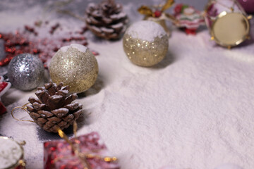 New Year's decorations, decorative elements - in the snow. Christmas trees, balls, snowflakes, gifts, cones. Christmas mood. Flatly photo. 