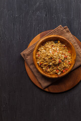 View from the top view of the granola with cranberries and strawberries in a wooden bowl