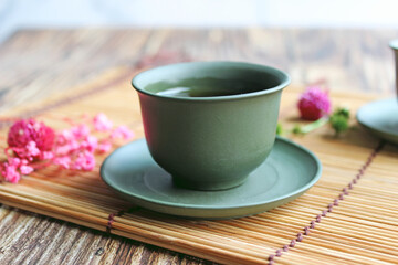 healthy green tea cup with tea leaves and flowers