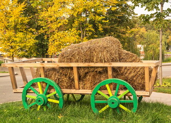 Rural landscape with a wooden cart with hay