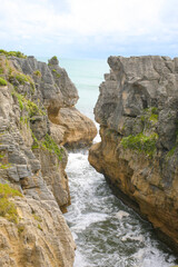 Fototapeta na wymiar The Pancake Rocks are a heavily eroded limestone area where the sea bursts through several vertical blowholes during high tides. Located on the Paparoa National Park, South Island, New Zealand.