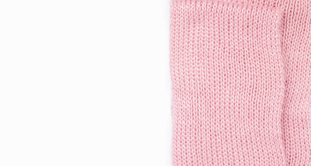 Knitting concept. Warm pink scarf on a white background. Copy space. View from above