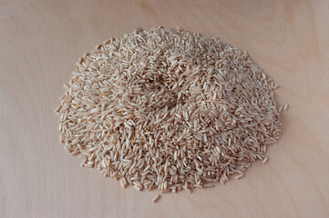 Brown rice on a plywood background