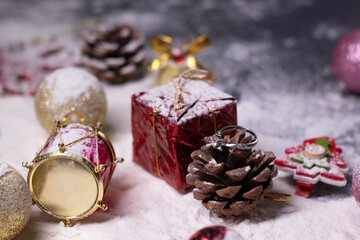 silver engagement ring jewelry next to New Year's decorations in the snow. Christmas trees, balls, snowflakes, gifts, cones. Christmas mood. Flatly photo. 