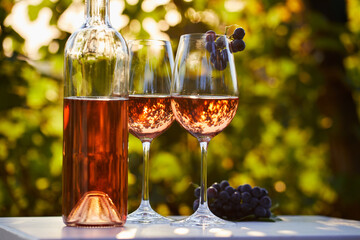 Two glasses and a bottle of rose wine on the table