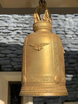 Close up shot of a golden bonsho bell in a Buddhist temple.