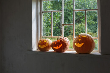 Halloween pumpkins on white windowsill