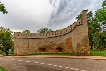 Fototapeta na wymiar Historical wall among the trees in Kezmarok by day, Slovakia
