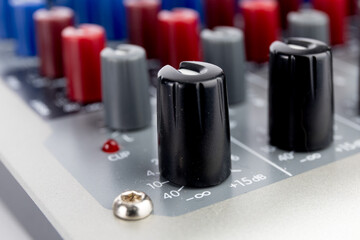 macro closeup of a levels potentiometer on a sound mixing board