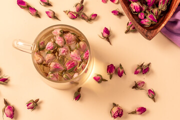 Large variety of multi colored dried tea leaves and flowers shot on white table