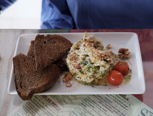 Scrambled eggs and toasts. Cherry tomatoes. Full breakfast. Sunday brunch. Slow food. Healthy menu.
