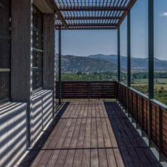 central perspective of modern building terrace with view to distant mountains