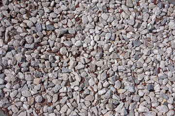 High angle full frame close-up view from directly above of an area of white gravel rocks