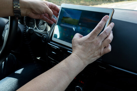 The driver of the car installs a tablet computer on the front panel as a car Navigator.