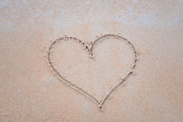 The sand is drawn in the shape of a heart.