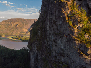 Aerial view of the high stone mountain. Amazing landscape with rocks. green forest and river cost. Wallpaper design.